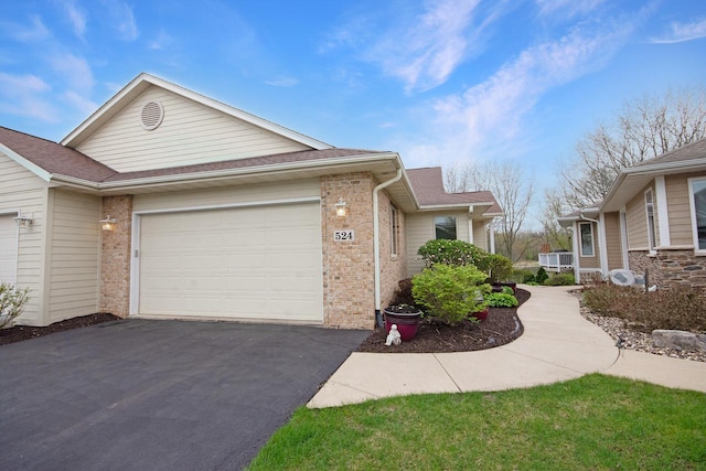 524 Tindalls Nest, Twin Lakes, WI 53181 - view of front of home with roof with shingles, an attached garage, brick siding, and aphalt driveway
