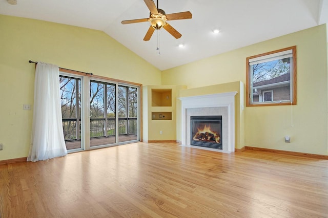 524 Tindalls Nest, Twin Lakes, WI 53181 - unfurnished living room featuring ceiling fan, light wood-style floors, baseboards, a fireplace with flush hearth, and vaulted ceiling