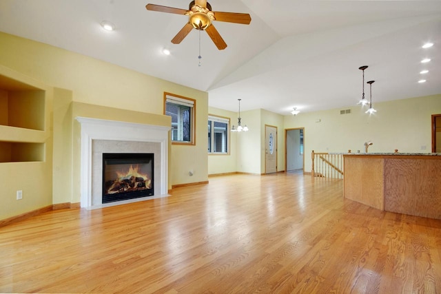 524 Tindalls Nest, Twin Lakes, WI 53181 - unfurnished living room with visible vents, a fireplace with flush hearth, a ceiling fan, and light wood-type flooring