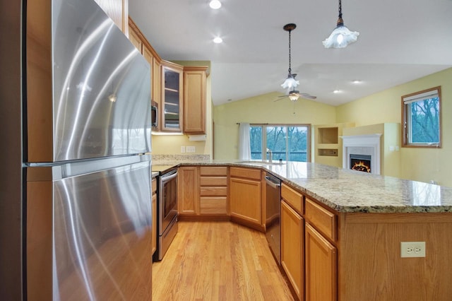 524 Tindalls Nest, Twin Lakes, WI 53181 - kitchen with a peninsula, light wood-style floors, ceiling fan, appliances with stainless steel finishes, and vaulted ceiling