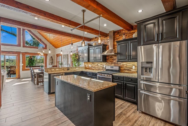 3024 Nagawicka Ave, Delafield, WI 53018 - kitchen with stainless steel appliances, wall chimney exhaust hood, a peninsula, light wood-type flooring, and a kitchen island