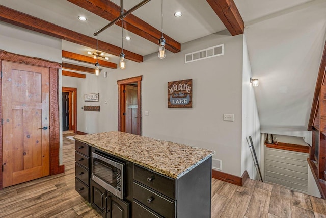 3024 Nagawicka Ave, Delafield, WI 53018 - kitchen featuring stainless steel microwave, beamed ceiling, light wood finished floors, recessed lighting, and light stone countertops