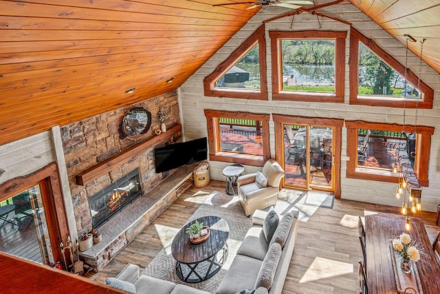 3024 Nagawicka Ave, Delafield, WI 53018 - living area with a fireplace, vaulted ceiling, wood ceiling, hardwood / wood-style flooring, and wood walls