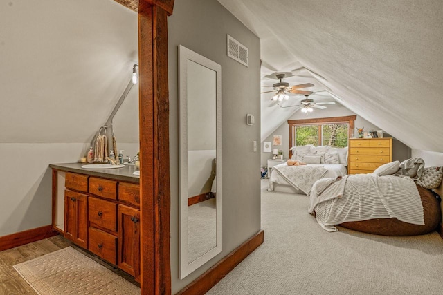 3024 Nagawicka Ave, Delafield, WI 53018 - bedroom with lofted ceiling, baseboards, a sink, light wood-style floors, and a ceiling fan