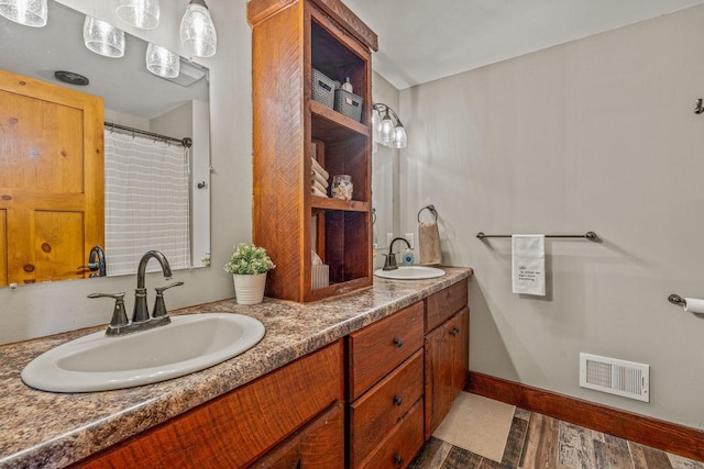 3024 Nagawicka Ave, Delafield, WI 53018 - full bath featuring wood finished floors, double vanity, and baseboards