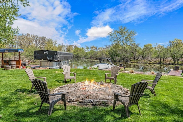 3024 Nagawicka Ave, Delafield, WI 53018 - view of grassy yard featuring an outdoor fire pit, a hot tub, and a water view