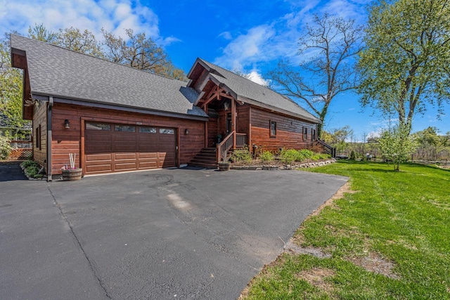 3024 Nagawicka Ave, Delafield, WI 53018 - chalet / cabin featuring driveway, a garage, a front yard, and a shingled roof