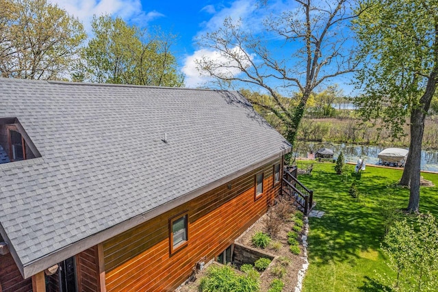 3024 Nagawicka Ave, Delafield, WI 53018 - view of home's exterior with a shingled roof, a lawn, and a water view