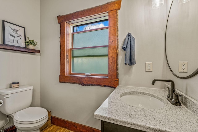 3024 Nagawicka Ave, Delafield, WI 53018 - half bathroom with toilet, vanity, wood finished floors, and baseboards