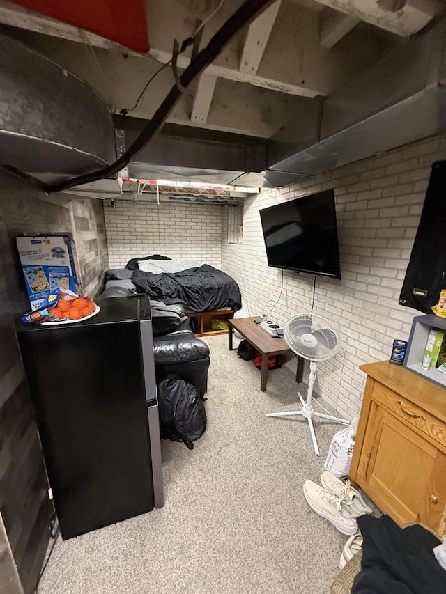 interior space with carpet floors and brick wall