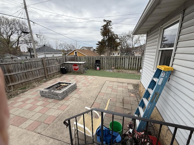 view of patio featuring a fenced backyard and an outdoor fire pit