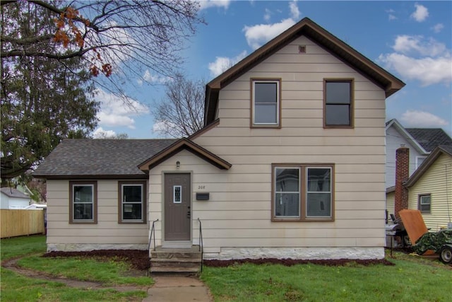 208 W Grand Ave, Chippewa Falls, WI 54729 - view of front of house featuring fence and a front lawn