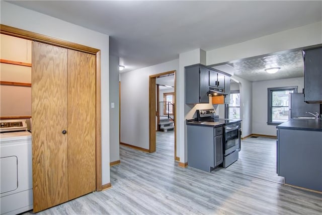 208 W Grand Ave, Chippewa Falls, WI 54729 - kitchen with washer / clothes dryer, dark countertops, stainless steel electric range oven, baseboards, and under cabinet range hood