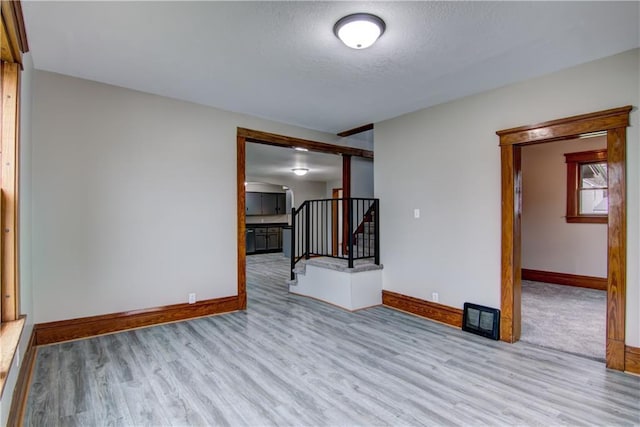 208 W Grand Ave, Chippewa Falls, WI 54729 - spare room featuring stairway, baseboards, a textured ceiling, and wood finished floors