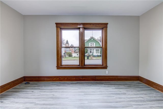 208 W Grand Ave, Chippewa Falls, WI 54729 - spare room featuring baseboards and wood finished floors