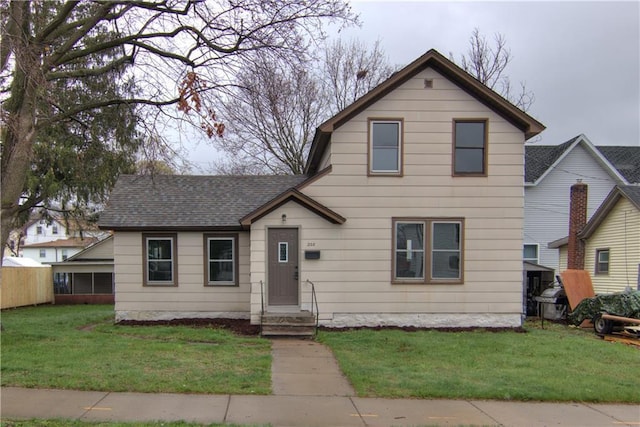 208 W Grand Ave, Chippewa Falls, WI 54729 - traditional-style home featuring a shingled roof and a front yard