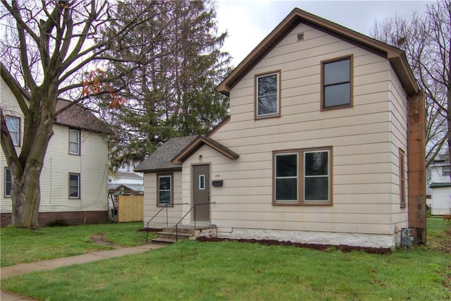 208 W Grand Ave, Chippewa Falls, WI 54729 - view of front facade featuring a front lawn