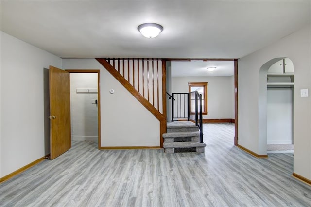208 W Grand Ave, Chippewa Falls, WI 54729 - interior space with baseboards, arched walkways, and wood finished floors
