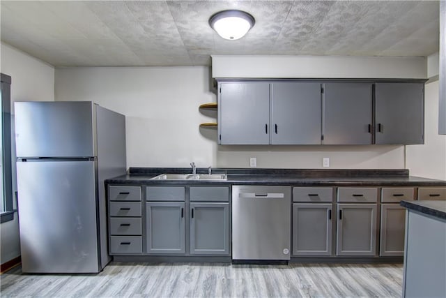 208 W Grand Ave, Chippewa Falls, WI 54729 - kitchen featuring appliances with stainless steel finishes, open shelves, light wood-type flooring, a sink, and gray cabinetry