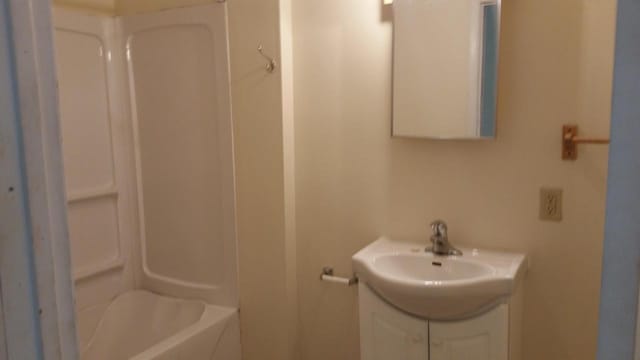 bathroom with vanity and  shower combination