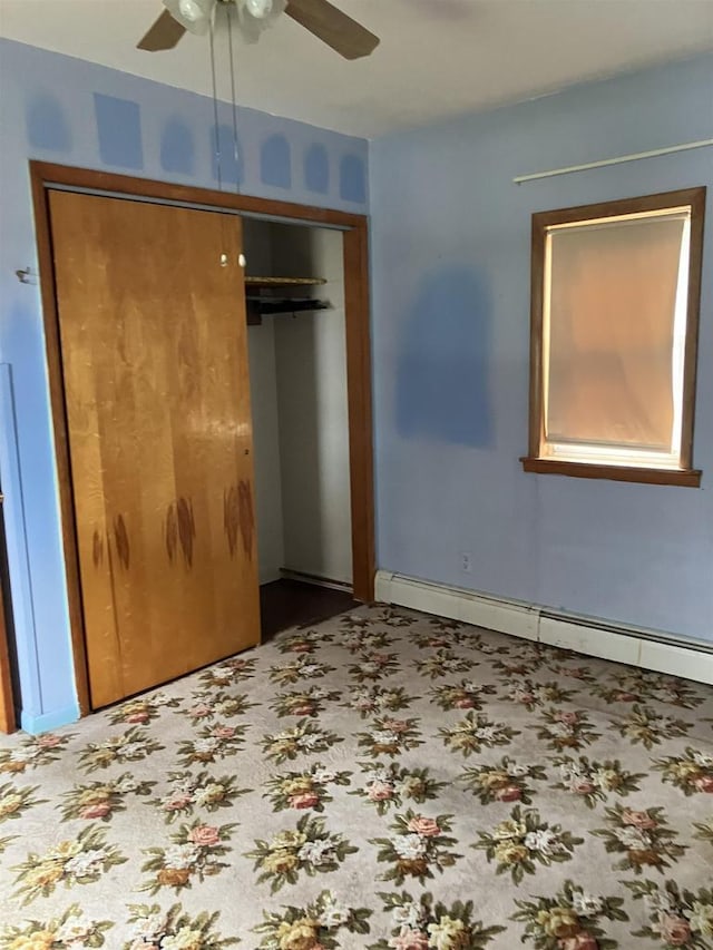 365 Jenkynsville Rd, Benton, WI 53803 - unfurnished bedroom with a ceiling fan, baseboard heating, a closet, and carpet floors
