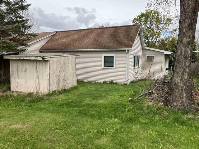365 Jenkynsville Rd, Benton, WI 53803 - exterior space featuring a lawn, an outbuilding, a shed, and roof with shingles