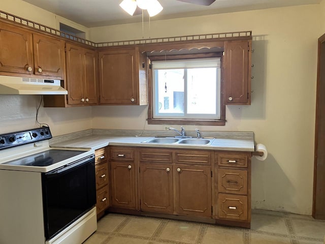 365 Jenkynsville Rd, Benton, WI 53803 - kitchen featuring a ceiling fan, light countertops, under cabinet range hood, a sink, and range with electric cooktop