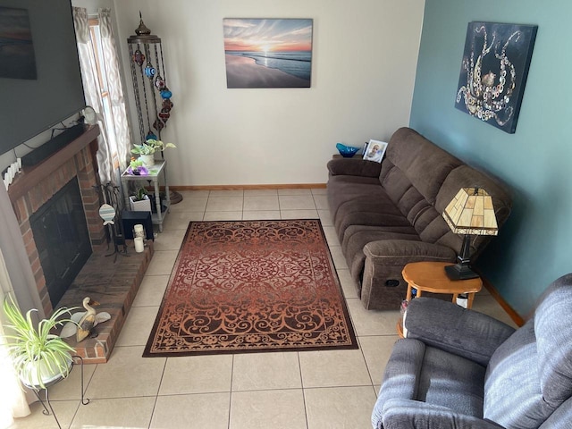 living area featuring baseboards, tile patterned flooring, and a fireplace
