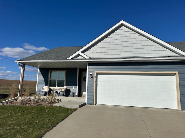 1817 Ridgewood Cir, Menomonie, WI 54751 - view of front of home with a porch, a garage, concrete driveway, and a shingled roof