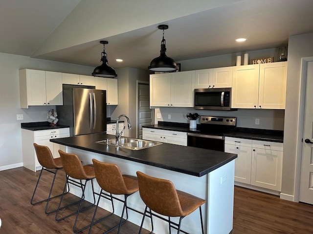 1817 Ridgewood Cir, Menomonie, WI 54751 - kitchen featuring appliances with stainless steel finishes, a sink, dark countertops, dark wood-style flooring, and lofted ceiling
