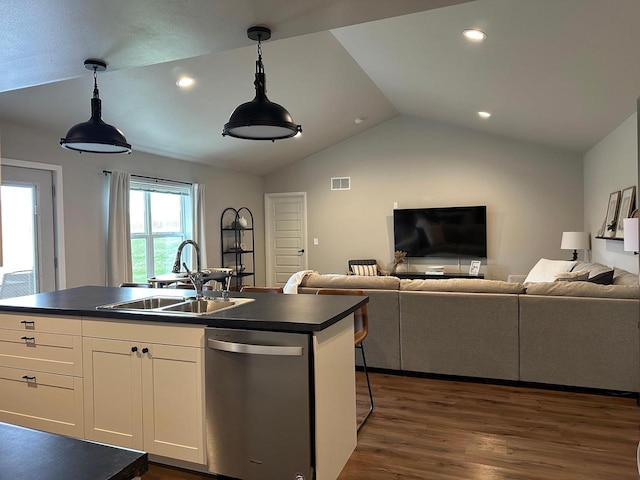 1817 Ridgewood Cir, Menomonie, WI 54751 - kitchen with stainless steel dishwasher, dark countertops, open floor plan, vaulted ceiling, and a sink