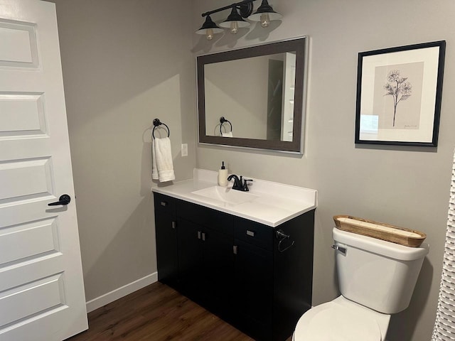 1817 Ridgewood Cir, Menomonie, WI 54751 - bathroom featuring toilet, wood finished floors, vanity, and baseboards