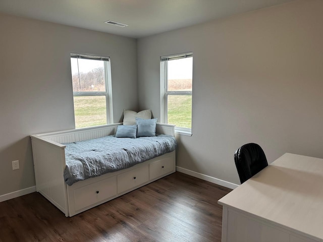 1817 Ridgewood Cir, Menomonie, WI 54751 - bedroom featuring multiple windows, wood finished floors, and baseboards