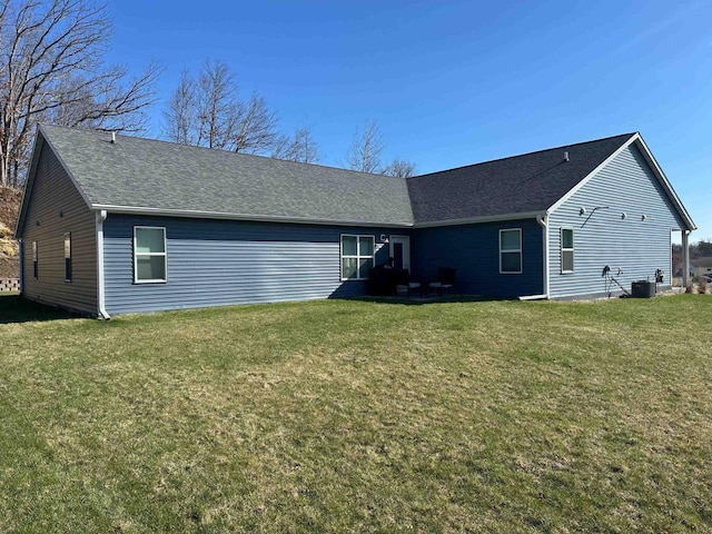1817 Ridgewood Cir, Menomonie, WI 54751 - rear view of property featuring cooling unit, a yard, and a shingled roof