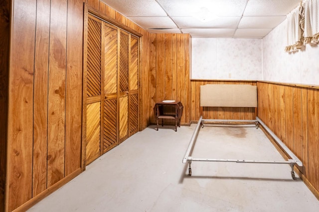101224 25th St, Chetek, WI 54728 - interior space with wooden walls, a wainscoted wall, and a drop ceiling