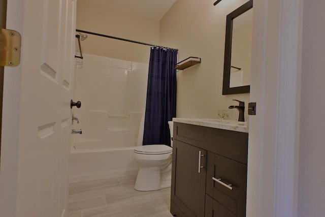 bathroom featuring vanity, shower / bath combo, and toilet