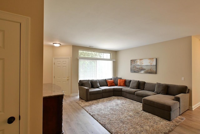 living room featuring baseboards and light wood finished floors