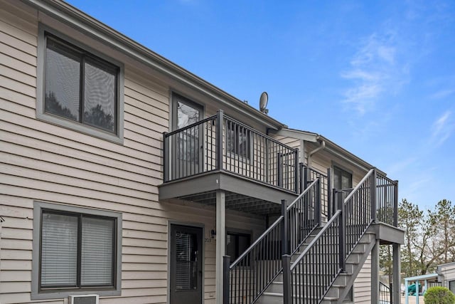view of property exterior featuring stairs and a balcony