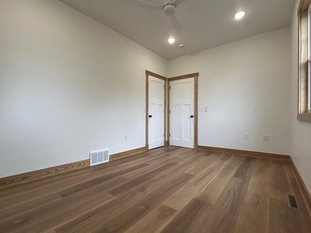 1019 Ellis Ave, Ashland, WI 54806 - unfurnished room featuring ceiling fan, visible vents, baseboards, and dark wood-type flooring