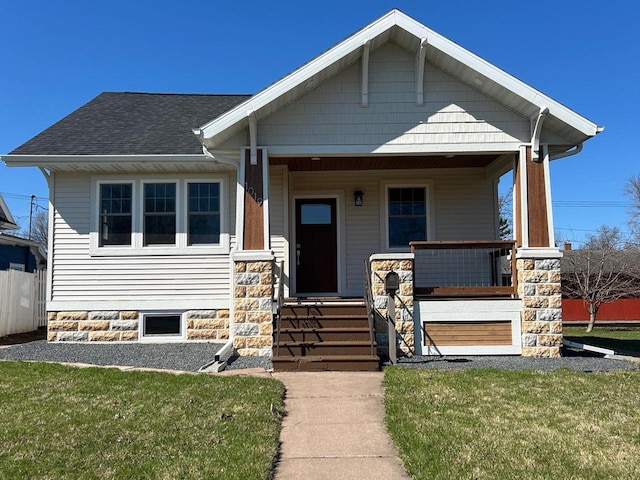 1019 Ellis Ave, Ashland, WI 54806 - view of front of house featuring a porch, a front lawn, and roof with shingles