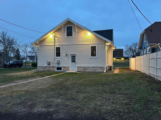 1019 Ellis Ave, Ashland, WI 54806 - rear view of house featuring fence and a lawn