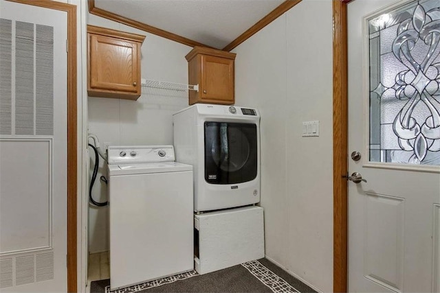 laundry room with crown molding, washer and clothes dryer, cabinet space, and a heating unit