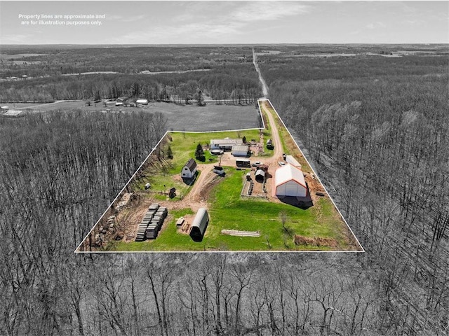 drone / aerial view with a wooded view