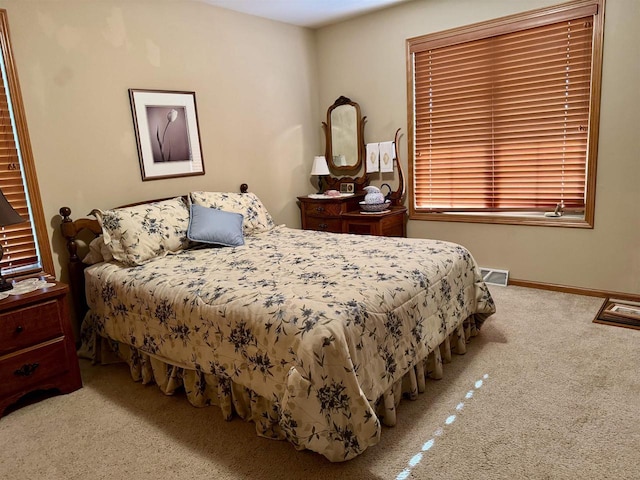 3027 S Bartells Dr, Beloit, WI 53511 - bedroom featuring carpet floors, baseboards, and visible vents