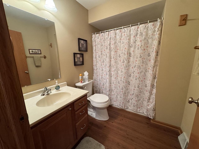 3027 S Bartells Dr, Beloit, WI 53511 - full bathroom featuring vanity, wood finished floors, toilet, and a shower with curtain