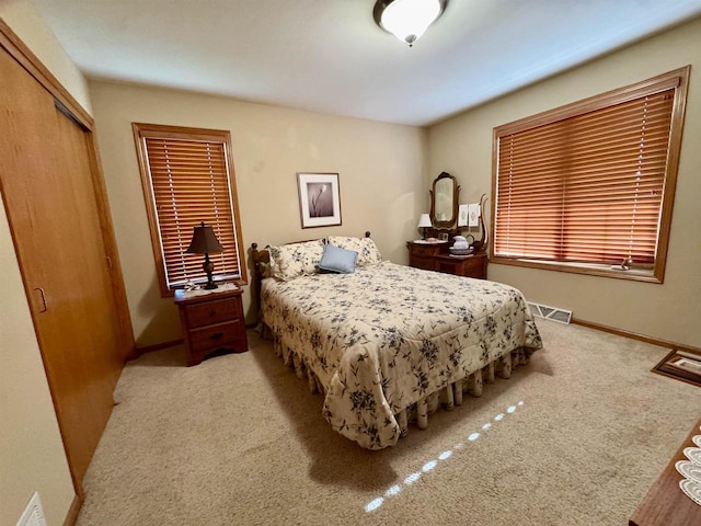 3027 S Bartells Dr, Beloit, WI 53511 - bedroom with baseboards, visible vents, carpet, and a closet