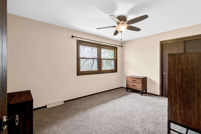 6643 Forest Park Dr, Deforest, WI 53532 - unfurnished bedroom featuring carpet floors, baseboards, a ceiling fan, and visible vents