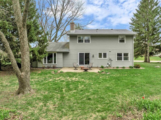 6643 Forest Park Dr, Deforest, WI 53532 - rear view of property featuring a chimney, a yard, and a patio area