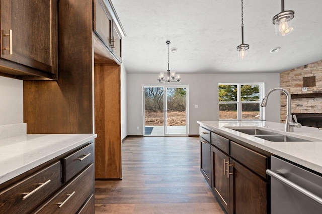 kitchen featuring dark brown cabinetry, light countertops, a sink, dark wood finished floors, and dishwasher