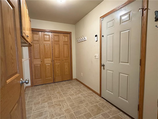interior space with baseboards and stone finish floor